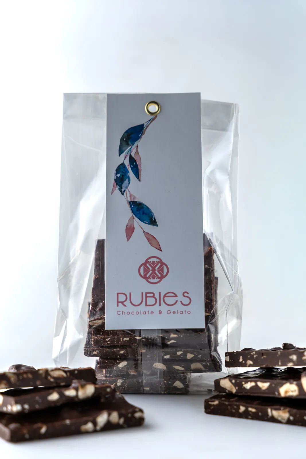 Cellophane bag of nut-studded dark chocolate bark with a Rubies header card