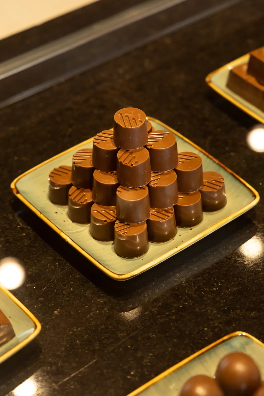 Bonbons arranged on a teal ceramic plate