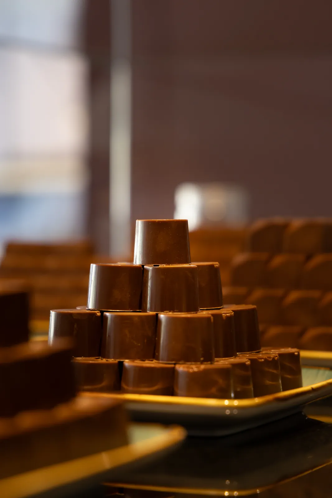 A warm-lit pyramid of chocolate bonbons