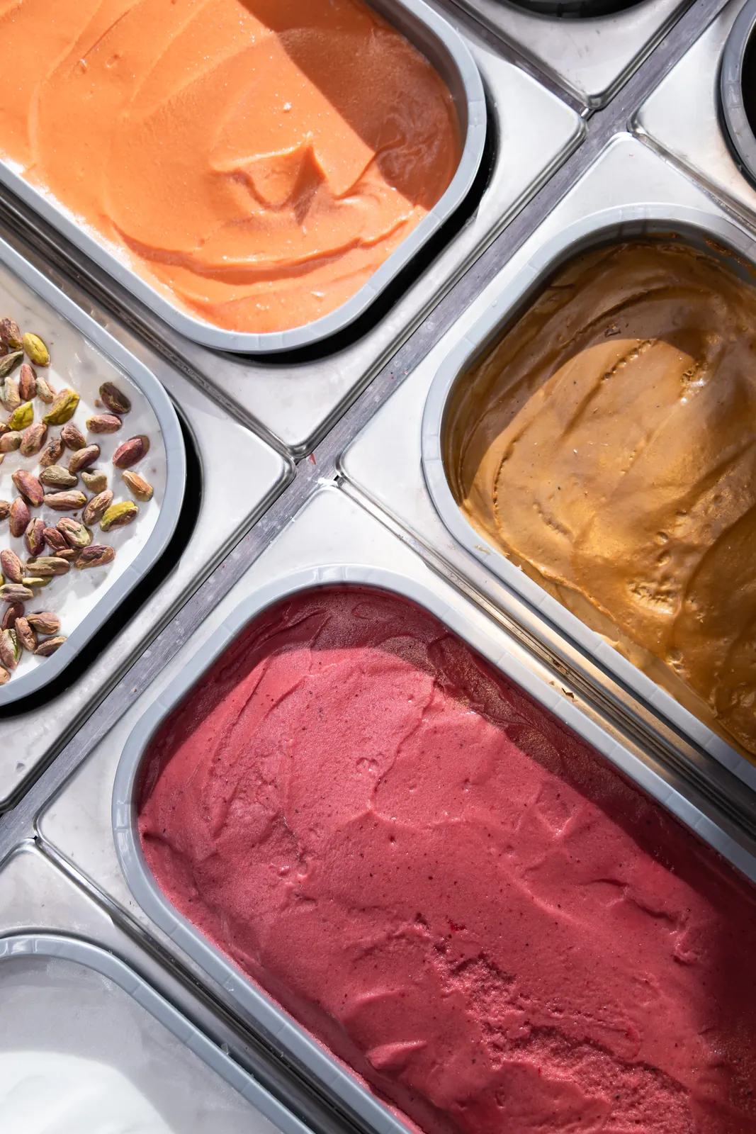 Overhead view of colorful gelato pans